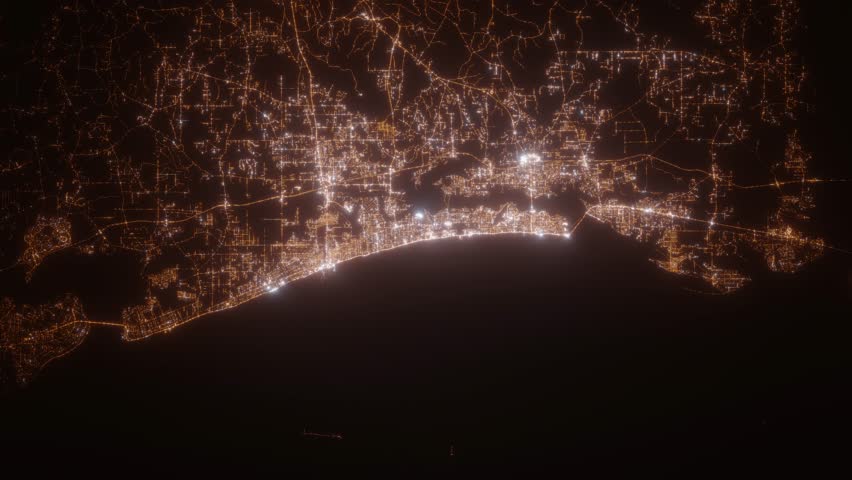 Biloxi (Mississippi, USA) aerial view at night. Satellite view on modern city with street lights. Camera is flying above the city, moving forward