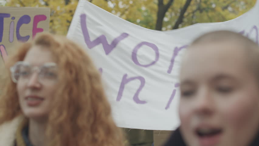 Group of initiative young women with empowerment posters and banners fighting for gender equality during demonstration protest on street Royalty-Free Stock Footage #3387976469