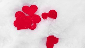 Valentines background. Red hearts falling on natural pure white soft snow surface. Symbol of love in winter holiday season. Romantic outdoor concept for Valentine's day copy space. Top view, close up. - Powered by Shutterstock - Get 15% off with code: PIKWIZARD15