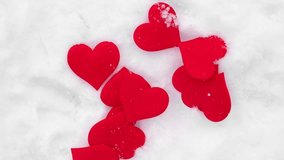 Valentines background. Red hearts falling on natural pure white soft snow surface. Symbol of love in winter holiday season. Romantic outdoor concept for Valentine's day copy space. Top view, close up - Powered by Shutterstock - Get 15% off with code: PIKWIZARD15