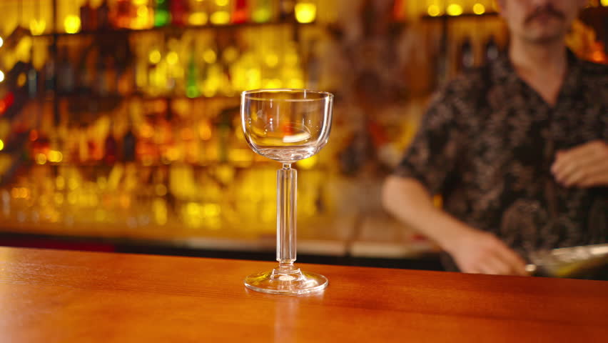 The process of making a cocktail by a bartender at the bar in club bar the concept of love for the preparation of alcoholic beverages