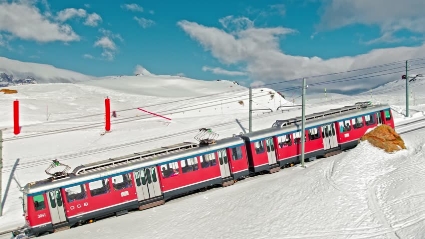 Aerial view of Swiss electrified cog railway train ride to the Gornergrat in Zermatt. View from above of the train with tourists in the Alps in Europe, Switzerland.