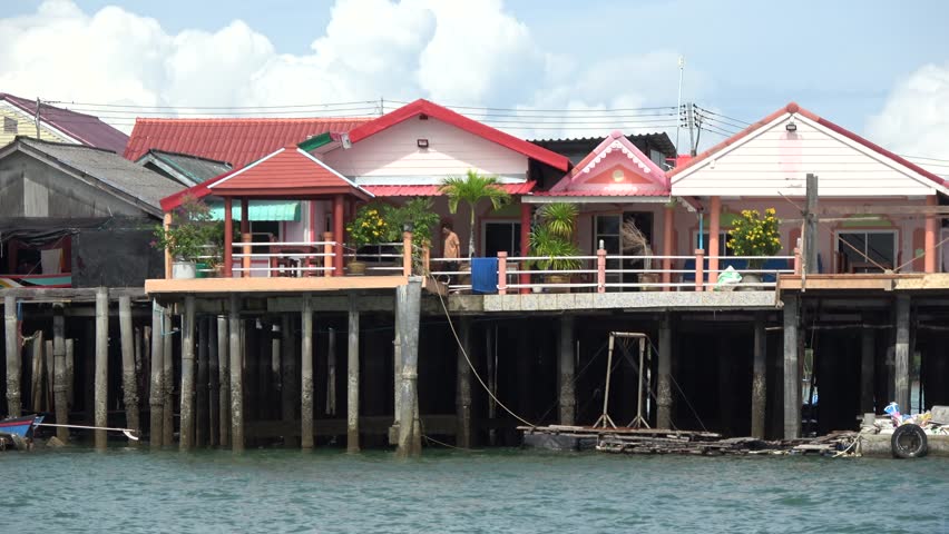 Sailing footage of stilt houses also called pile or lake dwellings are homes raised on stilts or piles over the surface of a body of water and are built primarily as a protection against flooding 4k