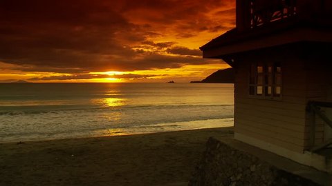 Beach house on sandy beach during beautiful sunrise