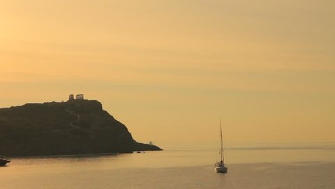Greece Cape Sounion. Ruins of an ancient temple of Poseidon at morning dawn, view from distance, time lapse