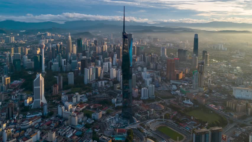 Aerial view time lapse 4k video of Kuala Lumpur city center view during dawn overlooking the city skyline in Federal Territory, Malaysia. Tilt up Royalty-Free Stock Footage #3389129937
