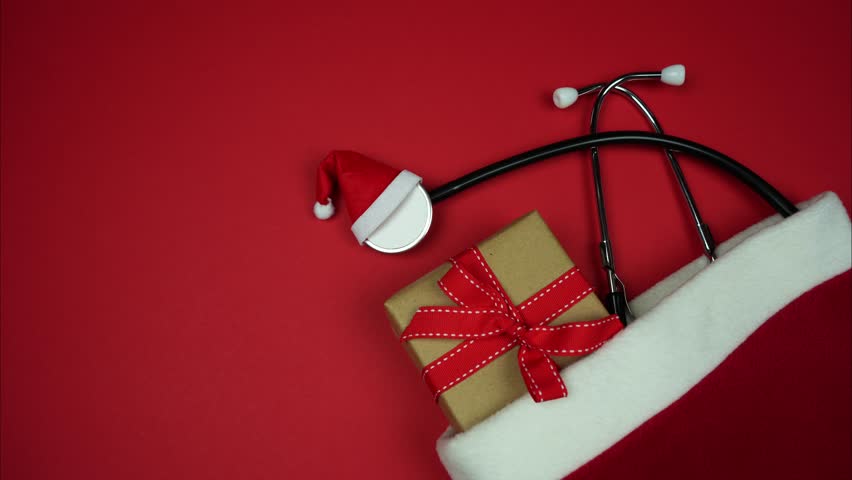 Christmas banner for medical industry. Stop motion animation of stethoscope and gift in red bag