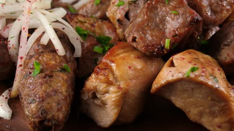 Grilled Kebabs, different kinds of meat cooked on grill, served with onion and spices, loop, ProRes codec, 422 HQ