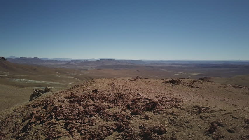 Hiker walks in front of scenic Bolivian vista