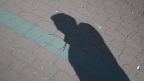 Shadow of a man, movement of a hand. A man puts on and takes off his glasses. Cutaway for video editing.