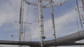 This video shows an empty trapeze performance area. 