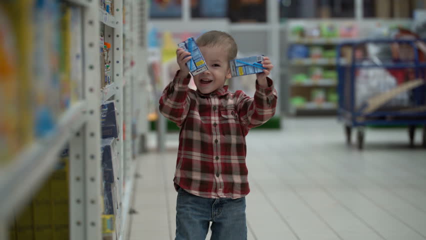 child buys baby food in a store or supermarket Royalty-Free Stock Footage #33894982
