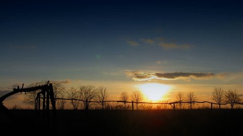 sunset over field, time lapse clip. no birds and free of defects.