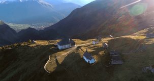BEALP, VALLIS, SWITZERLAND -OCTOBER 15: Cinema 4k aerial tilt view over a hotel and a church, on a sunny fall evening, on bealp, in wallis, of the alps in Switzerland.mp4
