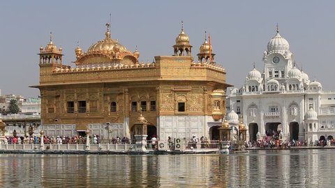 AMRITSAR, INDIA - SEPTEMBER 29, 2014: Unidentified Sikhs and indian people visiting the Golden Temple in Amritsar, Punjab, India. Sikh pilgrims travel from all over India to pray at this holy site.