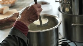 old man hands filling milk