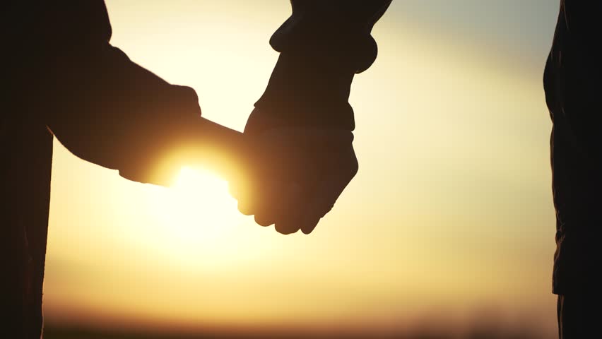 father holding her son hands. happy family kid dream concept. father take care her daughter holding her hands at sunset in the park close-up. hands lifestyle close-up parent and daughter