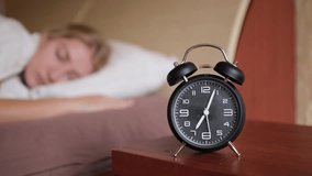Woman waking up with alarm clock ringing at 7 o'clock, everyday morning routine. - Powered by Shutterstock - Get 15% off with code: PIKWIZARD15