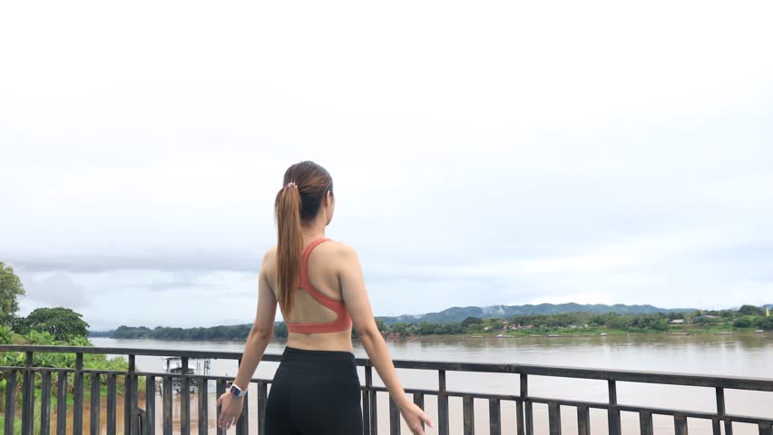 Young woman exercising in the morning wearing an orange dress.