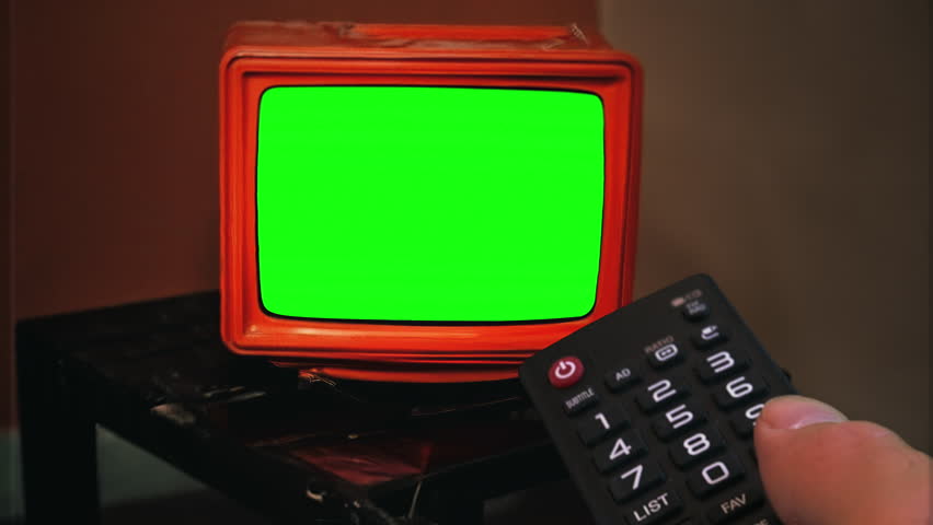 Channel Surfing Television Green Screen Remote Control Retro TV Zoom In. Remote control changing channels on an old vintage green screen television, zoom in. Royalty-Free Stock Footage #3390045651