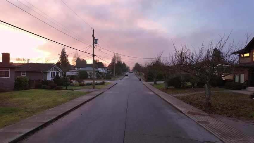 Road and Homes in Suburban Neighborhood, Sunset. Fall Season. Burnaby, British Columbia, Canada.