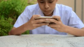 Boy are using a mobile phone to buy a product. And contact friends online.People use mobile phones to make purchases online.