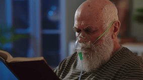 An elderly man is in a nursing home or in a hospital with bronchial asthma, suffers from a lack of air, cough and uses an oxygen mask to ease his breathing. A sick human follows medical therapy - Powered by Shutterstock - Get 15% off with code: PIKWIZARD15