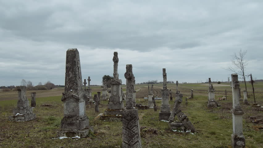 Large tombstone crosses on old graves against a blue sky background