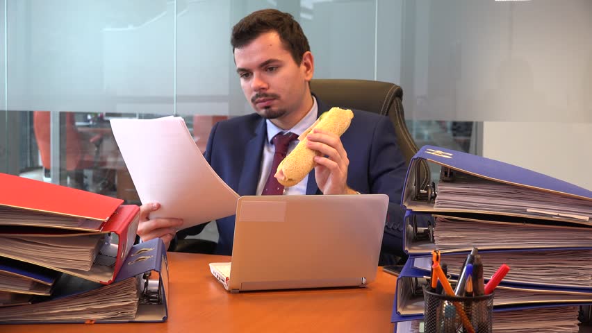Workaholic formal wear business man manager accountant reading paperwork eating  | Shutterstock HD Video #33903097