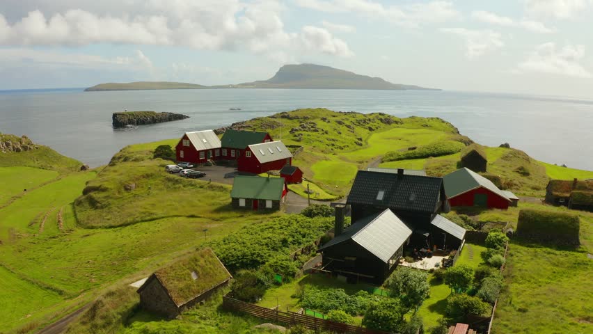 4k drone flight moving to the side footage (Ultra High Definition) of typical turf-top houses. Summer scene of outskirts of Torshavn city, capital of Faroe Islands, Denmark, Europe.