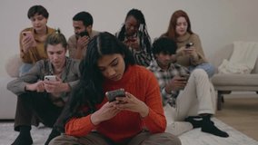 Young group of multiracial friends using smartphone. Happy diverse student people enjoying social media content smart mobile phone device. Technology concept. Playing game on mobile phone