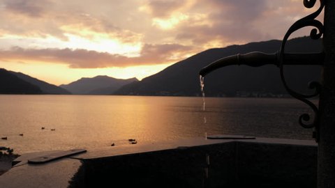 Lugano Lake. Fountain Slow Motion in Bissone, tiny village on the lake