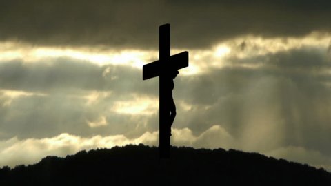 Silhouette of the Holy Cross on background of storm clouds.