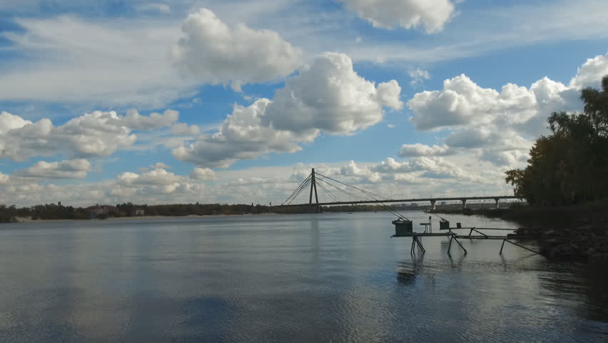 City landscape white clouds on a blue sky reflected in the Dnieper River