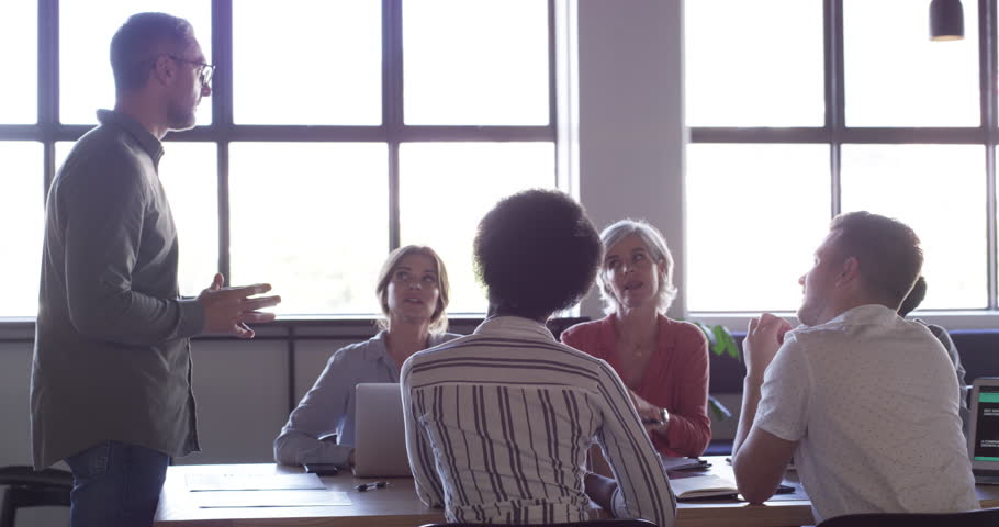 Project management meeting, business people and man consulting, teamwork and explain strategy development process. Group leader, creative agency and boardroom staff listen to boss collaboration plan