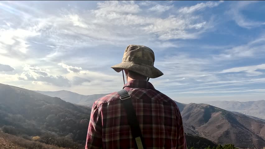 Hiker Looking at the Mountains

