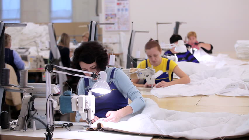 Women work in a sewing workshop. Working process at a textile factory. Modern textile factory Royalty-Free Stock Footage #3390535203