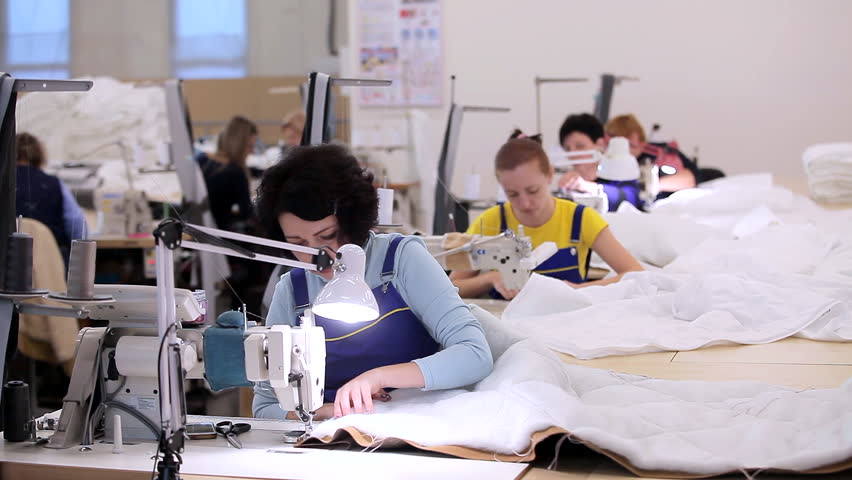 Women work in a sewing workshop. Working process at a textile factory. Modern textile factory Royalty-Free Stock Footage #3390535203