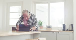 Tablet, video call and senior couple in kitchen with coffee for web, communication or conversation in their home. Digital, hello or old people embrace with tea in a house for online chat or speaking