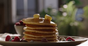 Sprinkling sugar powder on tasty pancake, slow motion. Cinematic, no people, advertisement. Lifestyle of cooking and domestic life, pleasant traditions. Healthy eating recipes for family on weekend