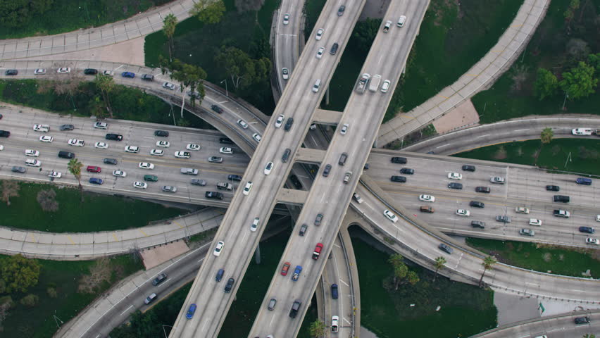 Aerial Overhead View of Famous Interchange in United States, Traffic in Interstate 110 and 10 Highway Full of Cars and Trucks Rush hour. Transportation. Royalty-Free Stock Footage #3390686063