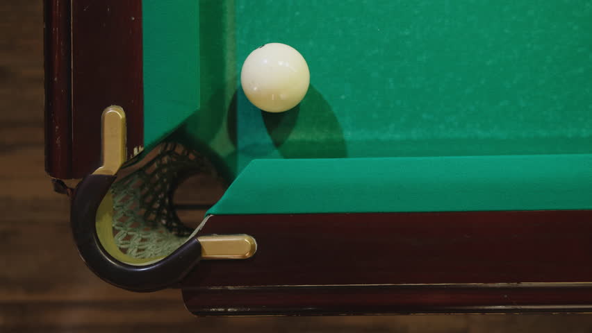 Playing billiard game. White pool balls close-up on green billiards table for start to play. Russian game, Russian pyramid. Billiard balls with numbers on a pool table. Billiards team sport. | Shutterstock HD Video #3390696685