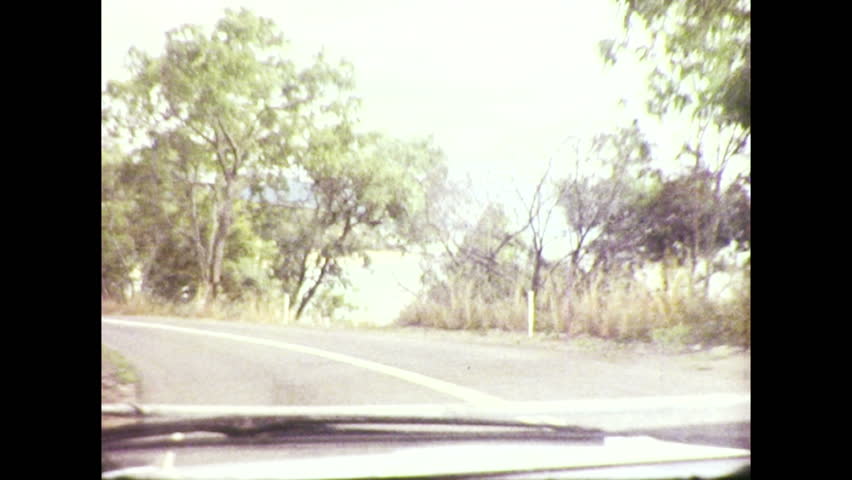 Vintage 8mm film footage of various road scenes on the highway from Cairns to