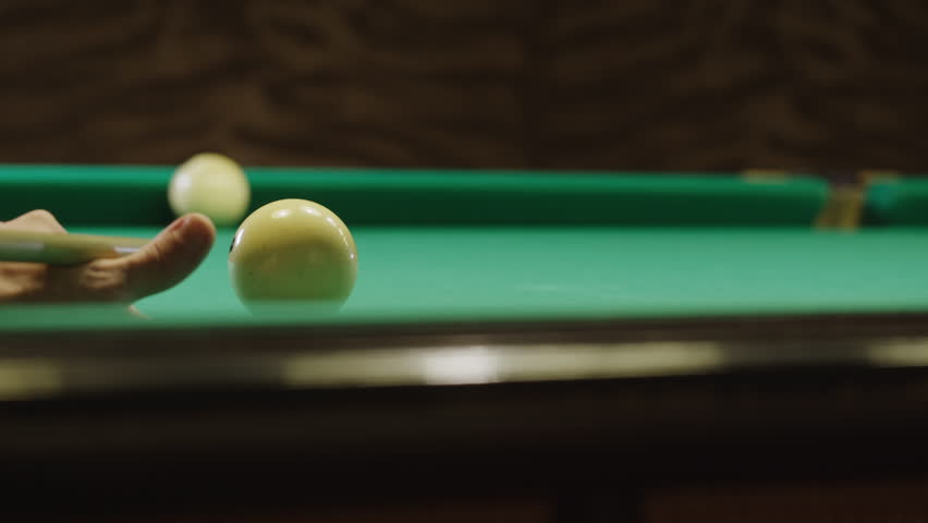 Playing billiard game. White pool balls close-up on green billiards table for start to play. Russian game, Russian pyramid. Billiard balls with numbers on a pool table. Billiards team sport. | Shutterstock HD Video #3390702077