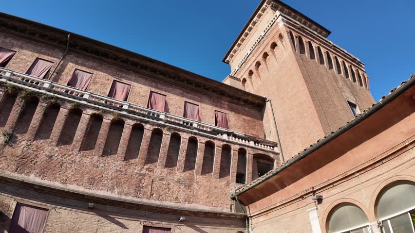 Ferrara Castle, known as Castello Estense, a medieval fortress in Ferrara center, Italy, constructed in 1385. Encircled by moat, Ferrara castle comprises sizable central block with four corner towers.