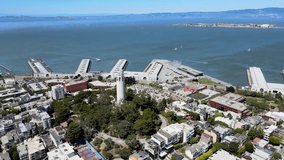 Coit Tower San Francisco Aerial View. Drone footage of Coit Tower overlooking the urban grid of San Francisco. Ideal for travel and historical content.