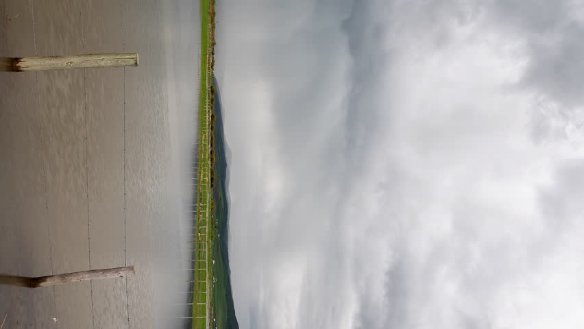 Vertical Timelapse of storm with lightning flash over flooded fields in Afton, Wyoming along the Salt River in Star Valley.