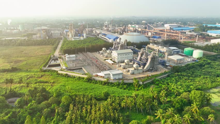 The drone captures the heart of the power plant, where turbines spin, generating electricity that powers cities and homes, an unseen force that keeps our world moving. Electric power industry.

