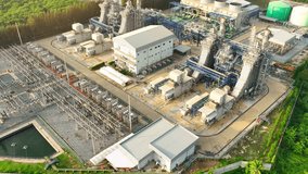 A Combined-Cycle Power Plant generates electricity by burning natural gas and reusing waste heat, making it both environmentally friendly and economically viable. Bird's eye view by drone.
