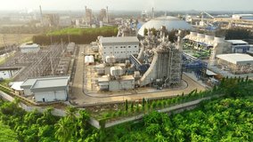 A Combined-Cycle Power Plant is an energy facility that maximizes efficiency by using both gas and steam turbines to generate electricity. It harnesses waste heat to boost power output. Drone. 4K.
